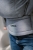 Modelka nosi dziecko w ergonomicznym nosidle KAVKA multi-age ink twill - niebieskie nosidlo z delikatnym wzorem w jodelke (a blue carrier with a twill delicate herringbone pattern) pas biodrowy